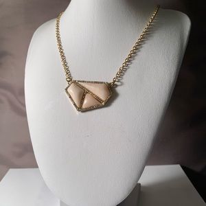 Gold colored necklace with asymmetric stone